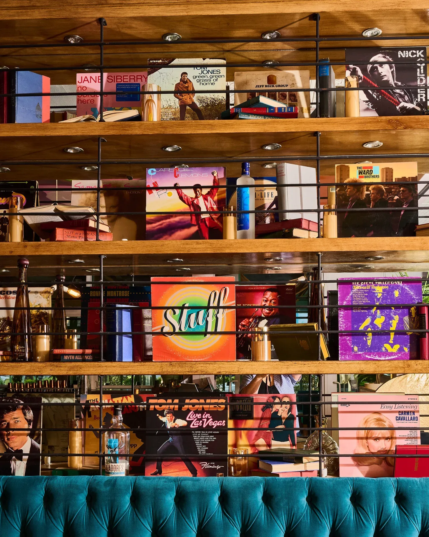 A wall of colorful records above Rosetta's teal banquette
