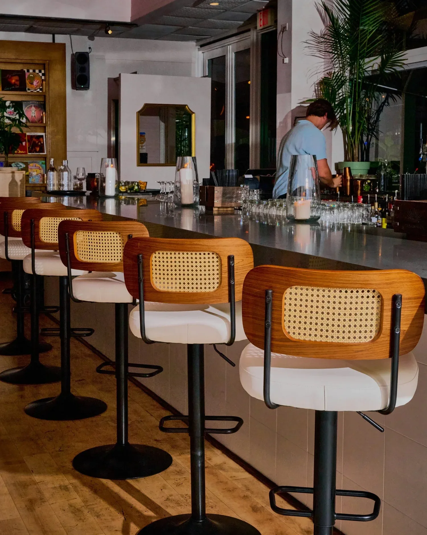 Rosetta's pale stone bar with cane-backed stools