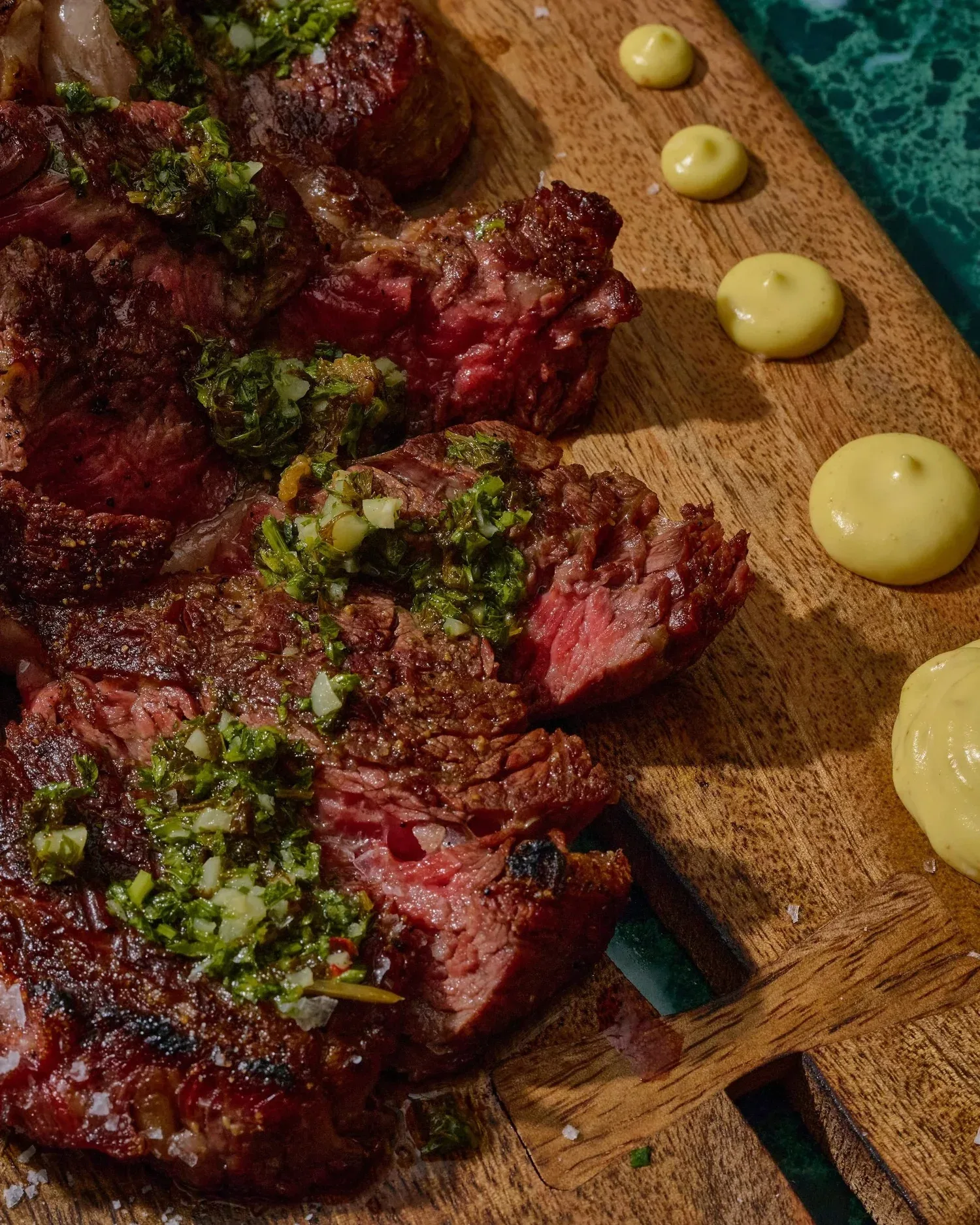 Sliced wood-fired steak with salsa verde
