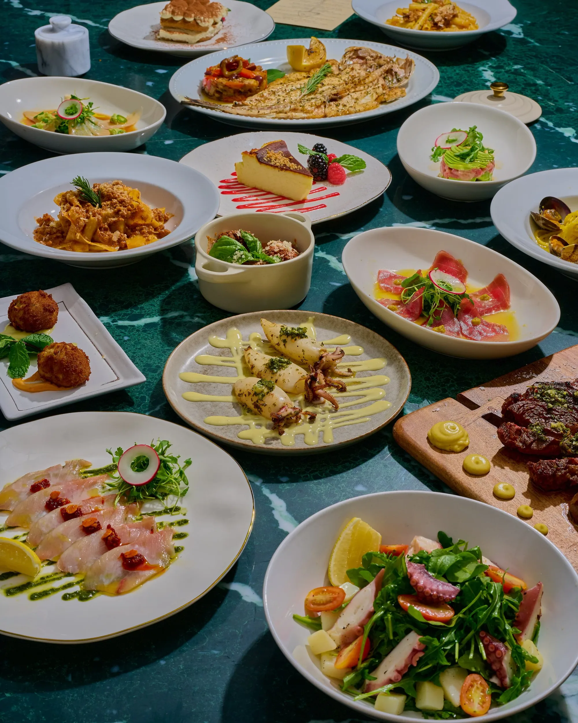 A full Rosetta table with crudo, pasta, fish, and dessert